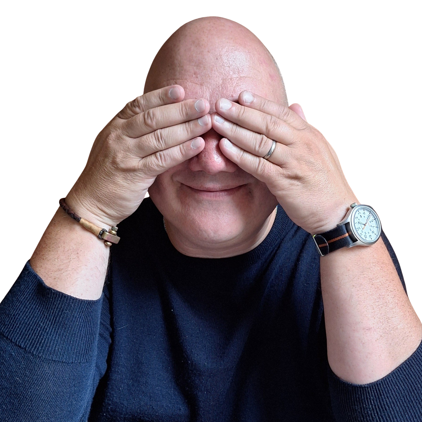 A person wearing a dark sweater and a watch covers their eyes with both hands, smiling, against a black background.