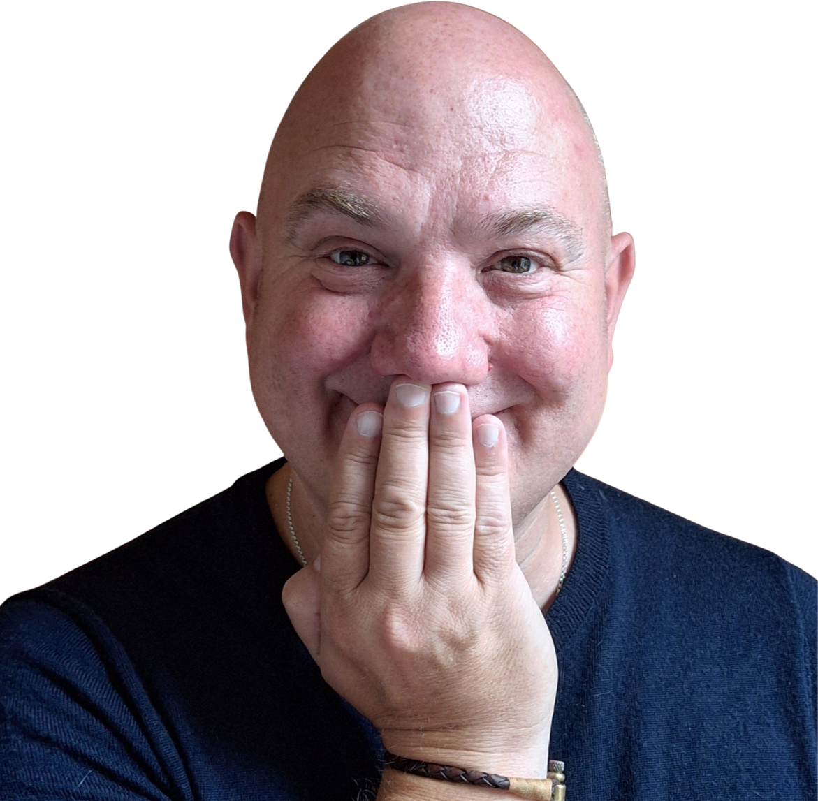 A bald man wearing a dark shirt smiles with his eyes and covers his mouth with his hand, as if trying to hide laughter or amusement.