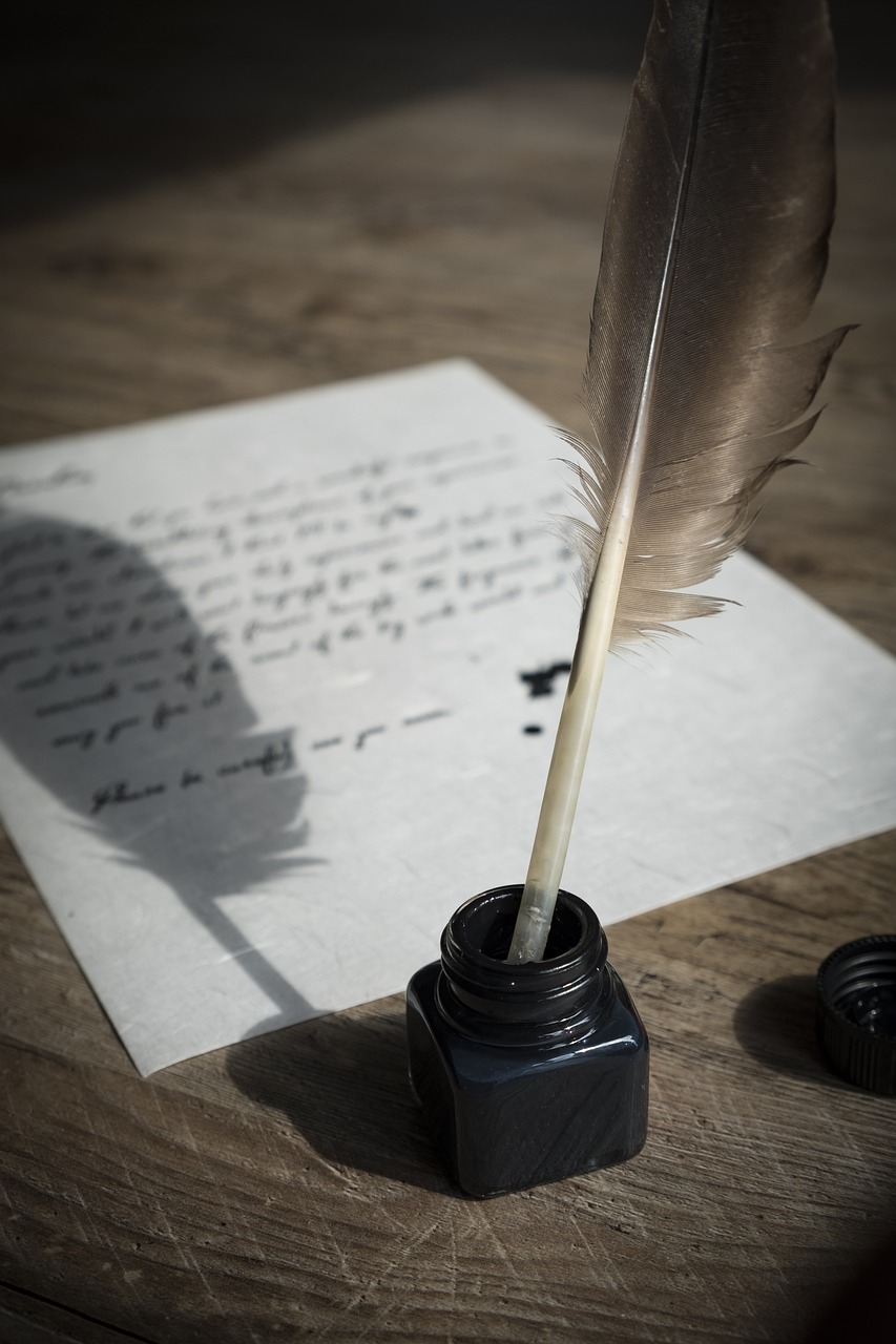 A feather quill rests in a black ink bottle on a wooden surface, with a handwritten letter titled The Certainty of Chance in the background. The scene is softly lit, creating a nostalgic and vintage atmosphere.